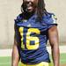 Michigan senior quarterback Denard Robinson reacts to a teammate during media day at the Al Glick Field House on Sunday afternoon. Melanie Maxwell I AnnArbor.com